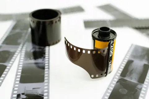 Zastanawiasz się, ile kosztuje wywołanie kliszy Kodak? Na zdjęciu widać rolki i paski negatywów filmowych, gotowe do obróbki.